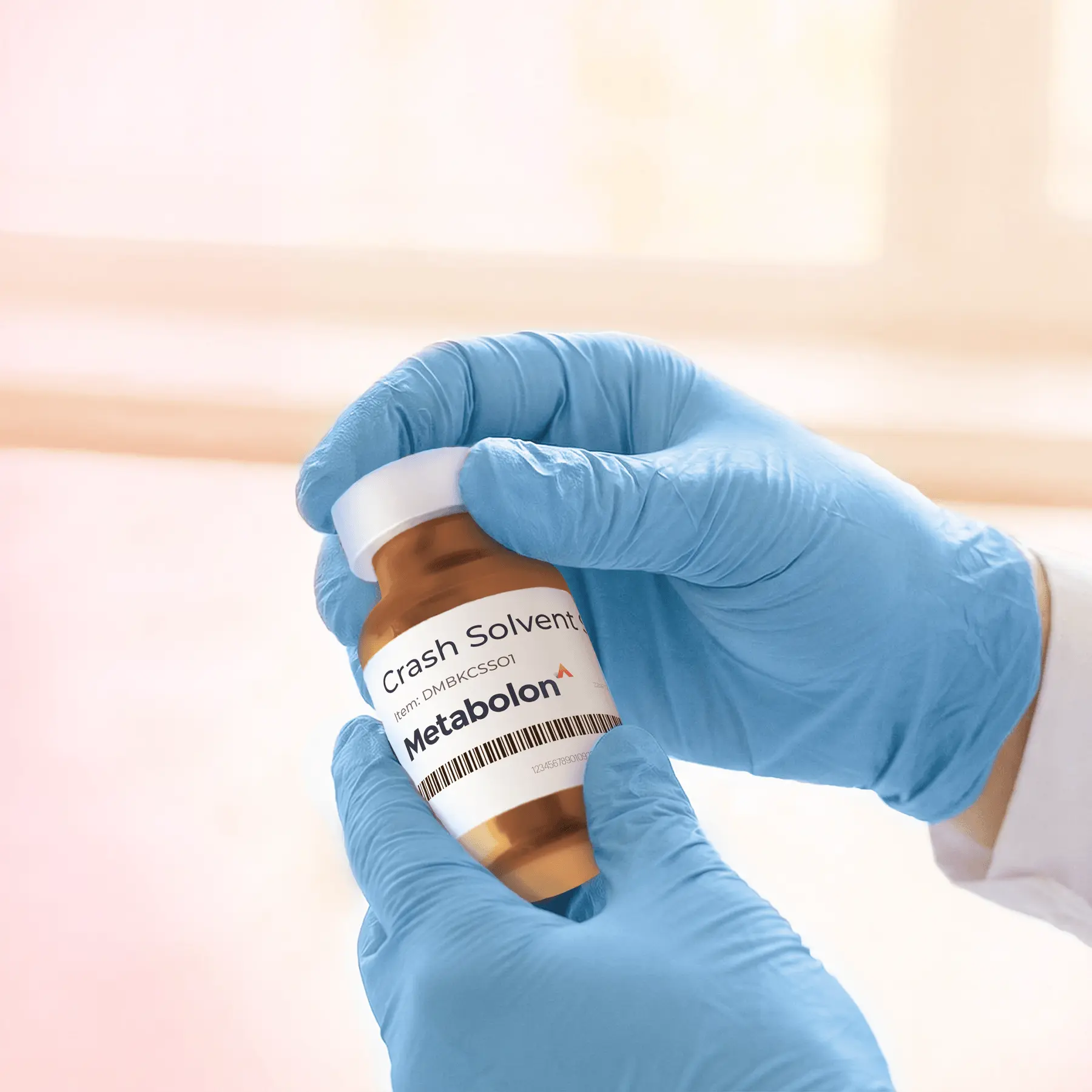 Gloved hand holds Metabolon reagent vial
