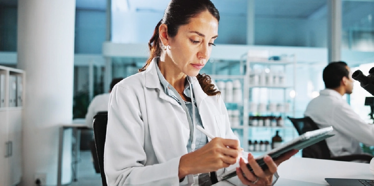 pharma executive works on a clipboard