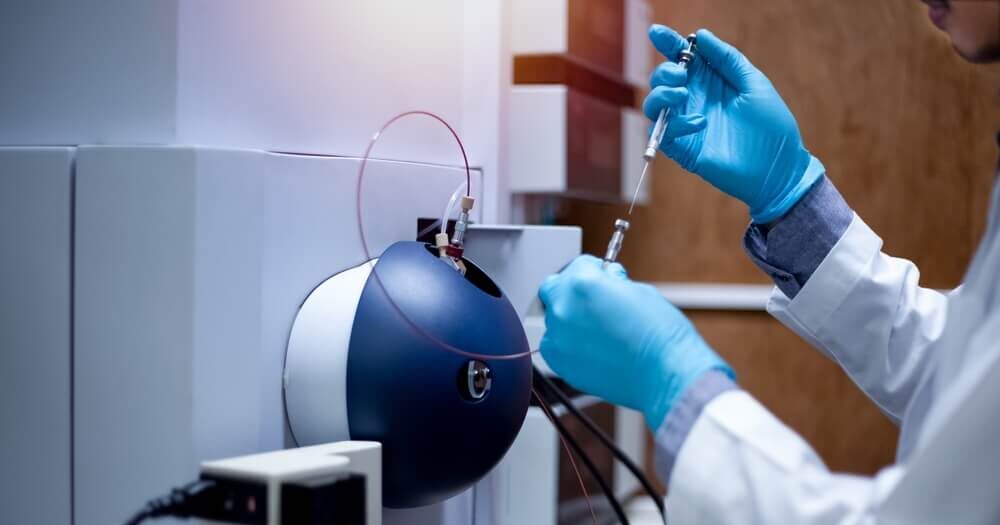 scientist works with a mass spec instrument