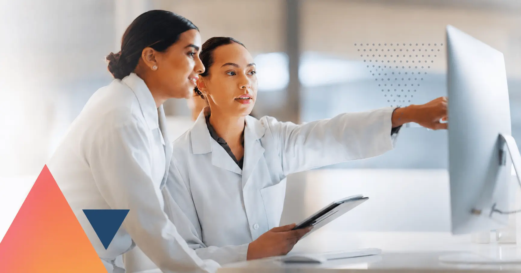 two scientists study a monitor together