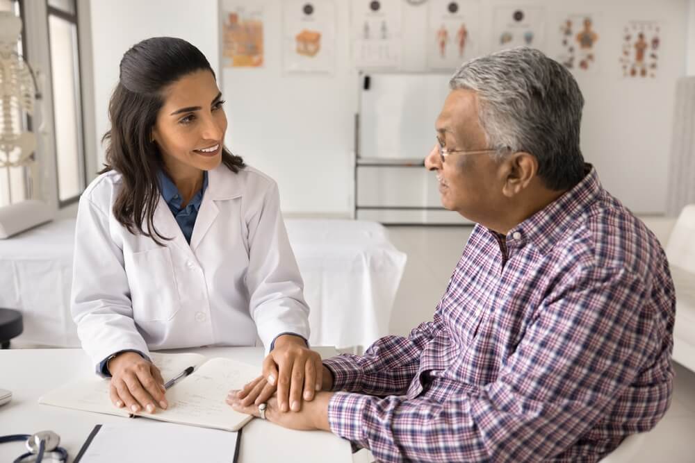 physician and patient talk together